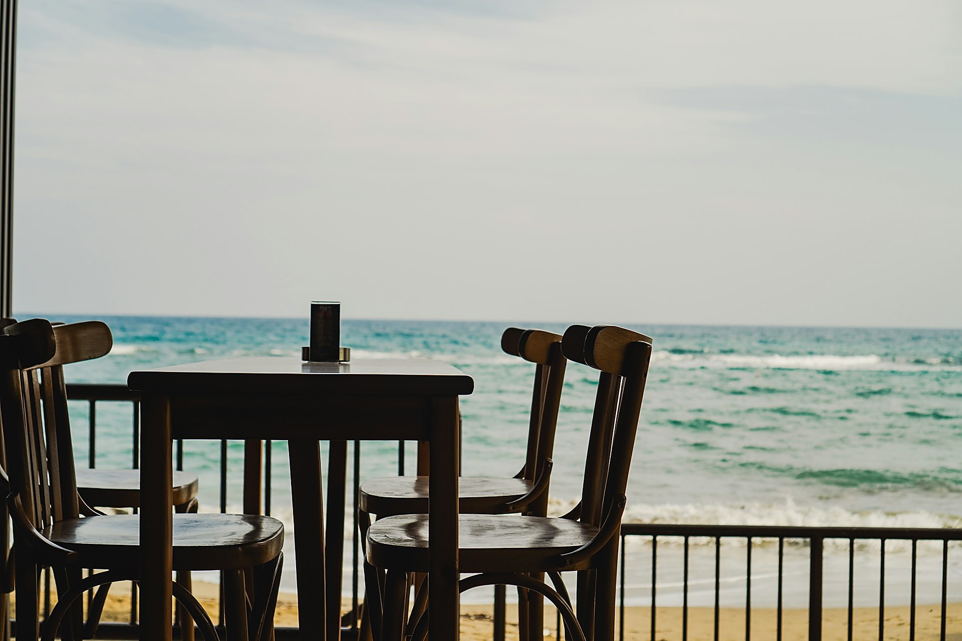 Beachfront dinner table at sunset by the ocean